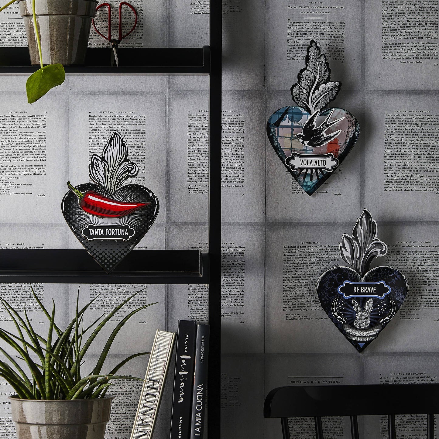A decorative heart-shaped wall art with a 'Be Brave' motivational quote, a hare motif, and leaf details, predominantly in black, blue, and white colors.