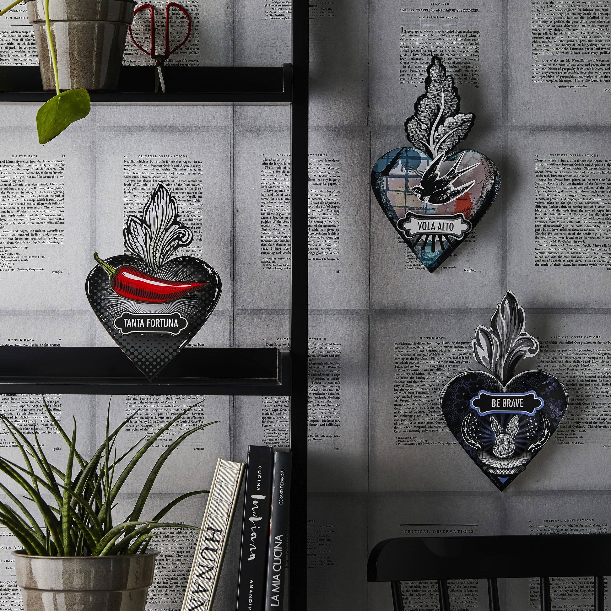 A decorative heart-shaped wall art with a 'Be Brave' motivational quote, a hare motif, and leaf details, predominantly in black, blue, and white colors.