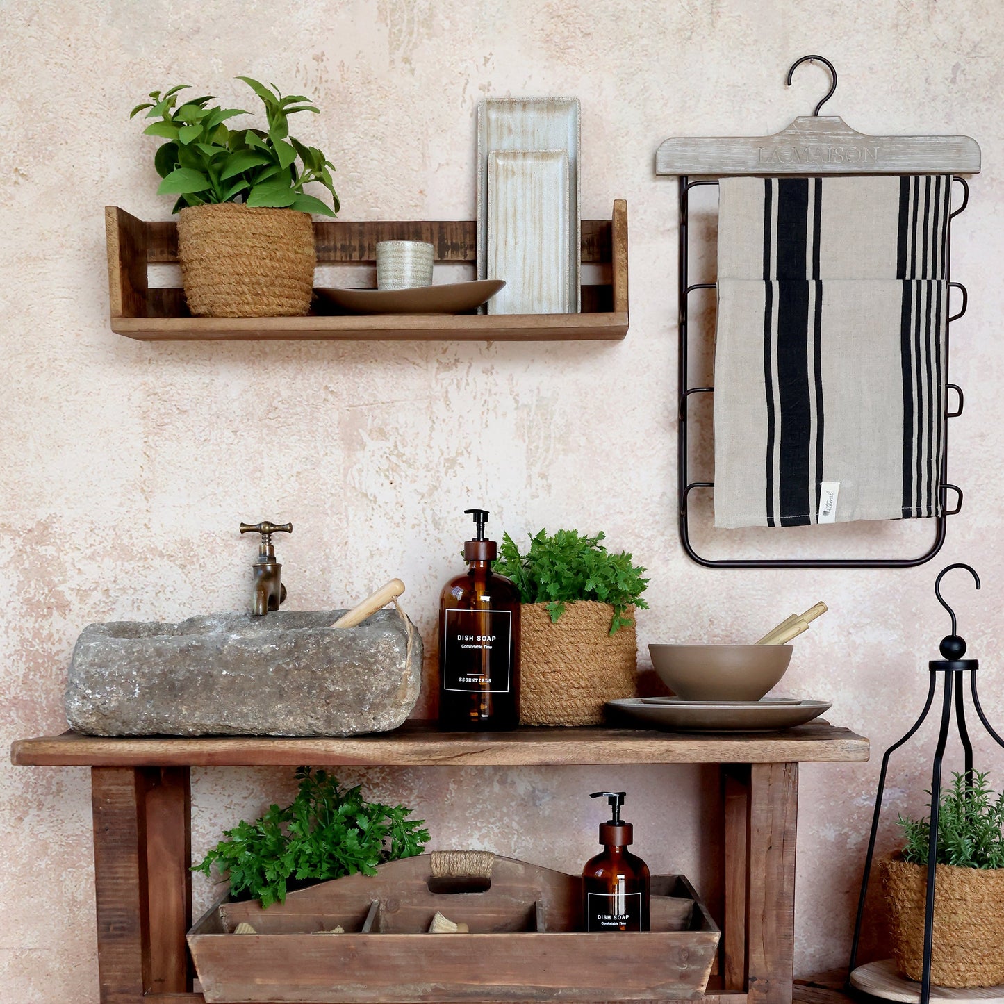 mocca glass dish soap pump bottle on a rustic wooden table with kitchen decor and plants.