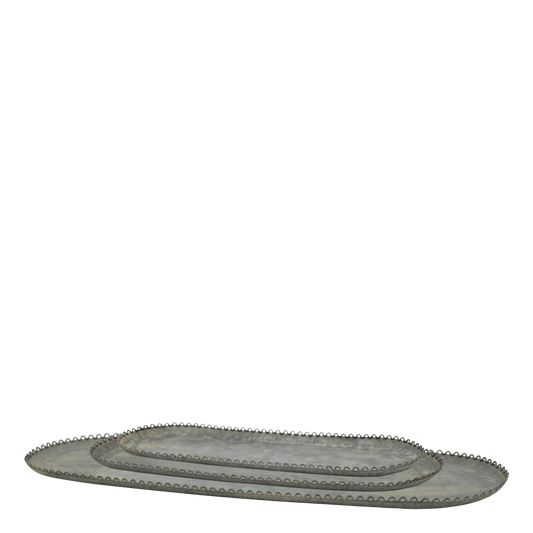 Set of oval metal trays with decorative edges on a white background