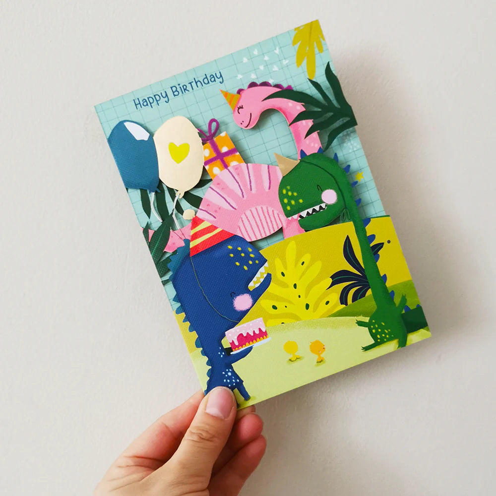 Birthday card with dinosaurs held by a hand