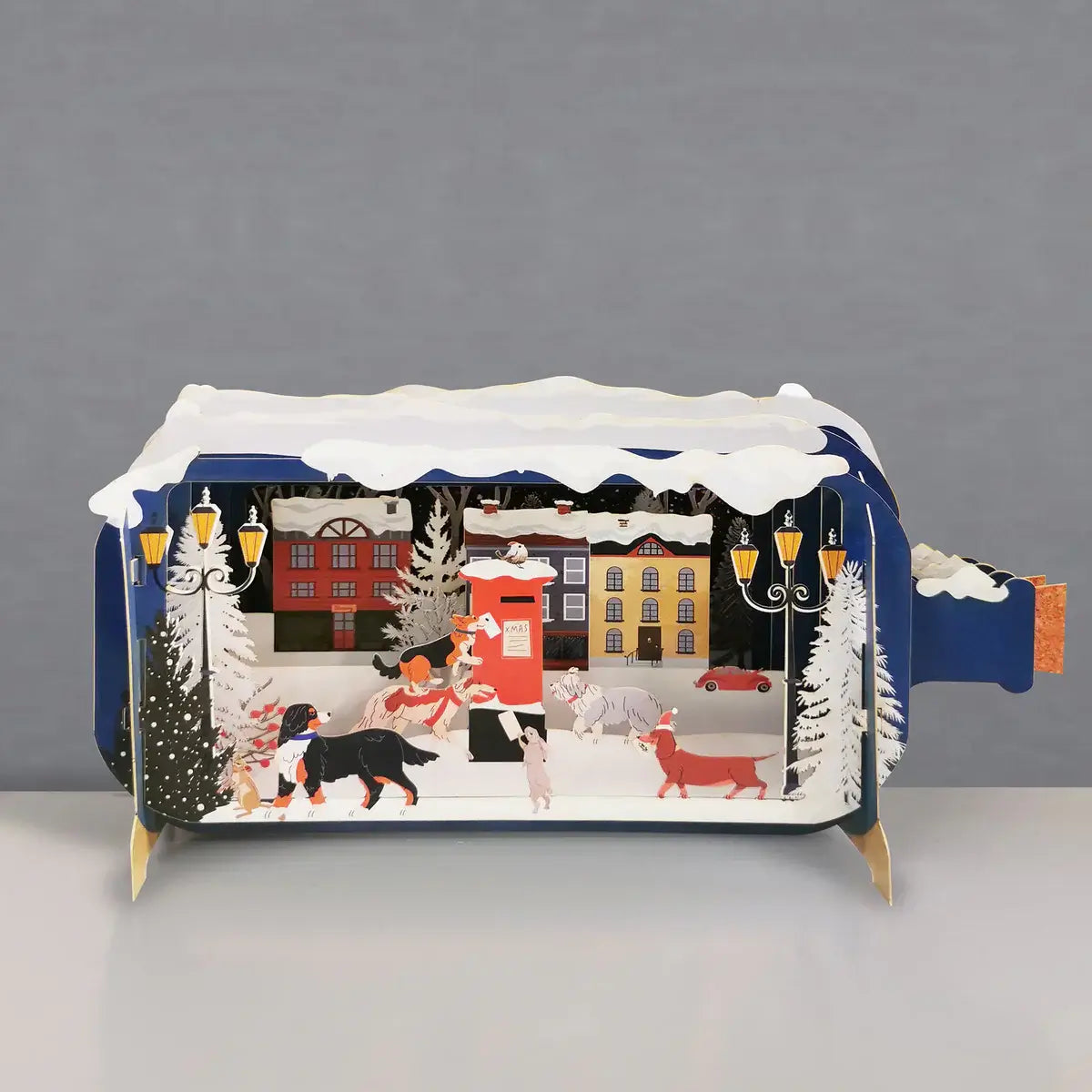 Decorative csrd with a winter scene design featuring people and dogs in a snowy village.