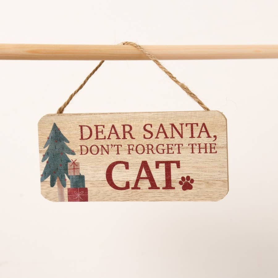 Wooden sign with Christmas design and text 'Dear Santa, don't forget the cat' on a white background.
