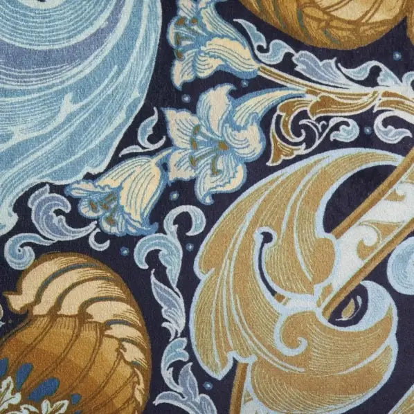 Close-up of decorative fabric with floral and wave patterns on a dark blue background