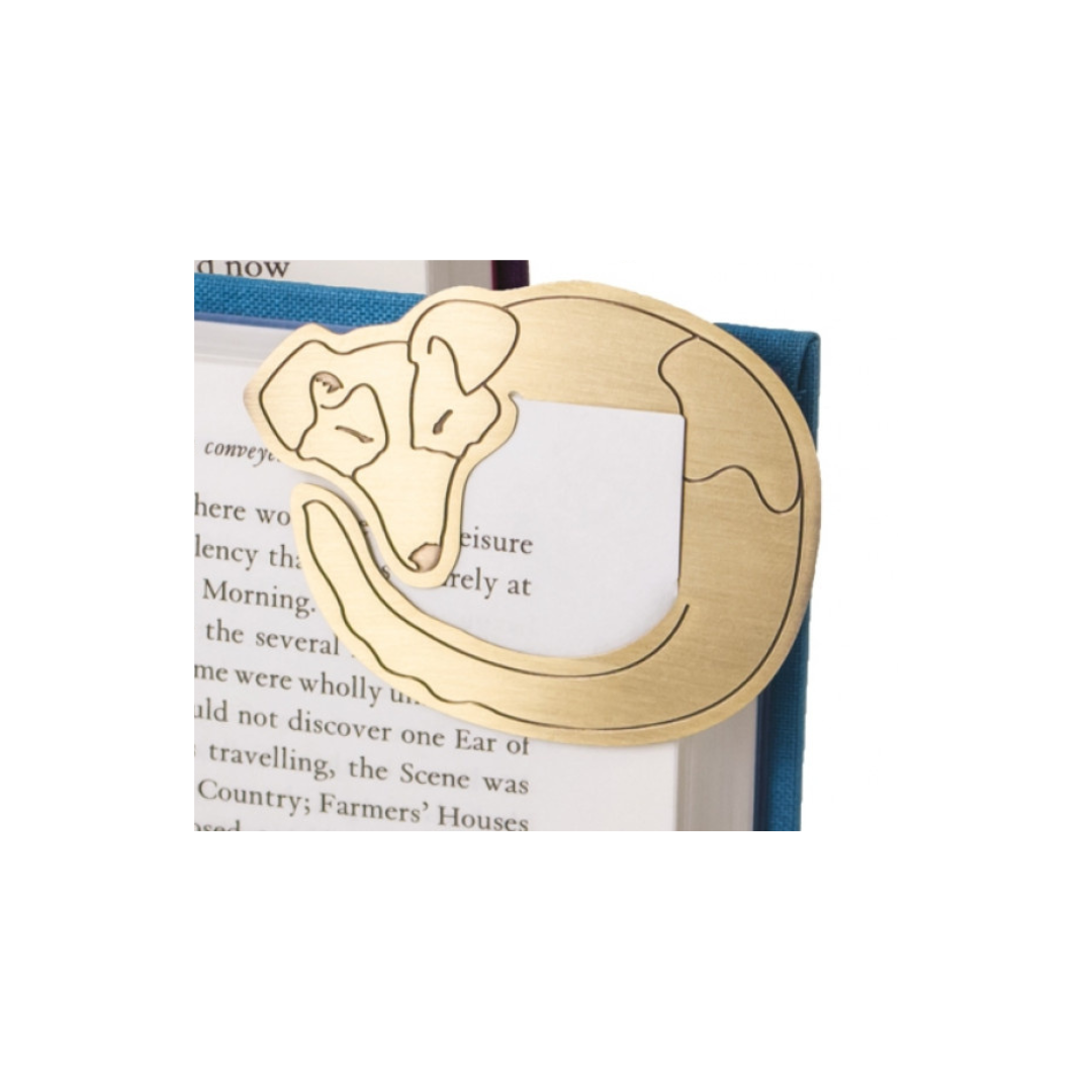 Gold bookmark shaped like a dog on a white background