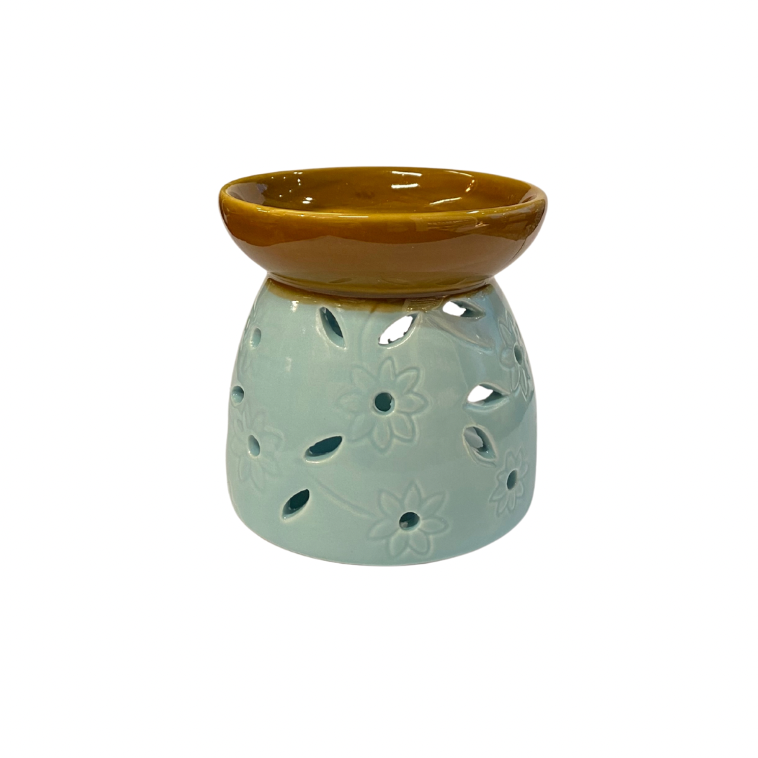 Ceramic oil burner with brown top and light green base on a white background