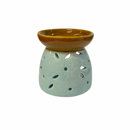 Ceramic oil burner with brown top and light green base on a white background