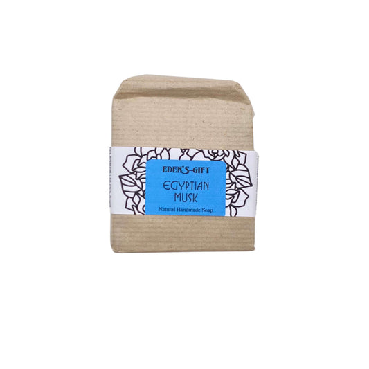 A bar of handmade soap wrapped in brown paper with a blue and white label that reads 'Egyptian Musk'.