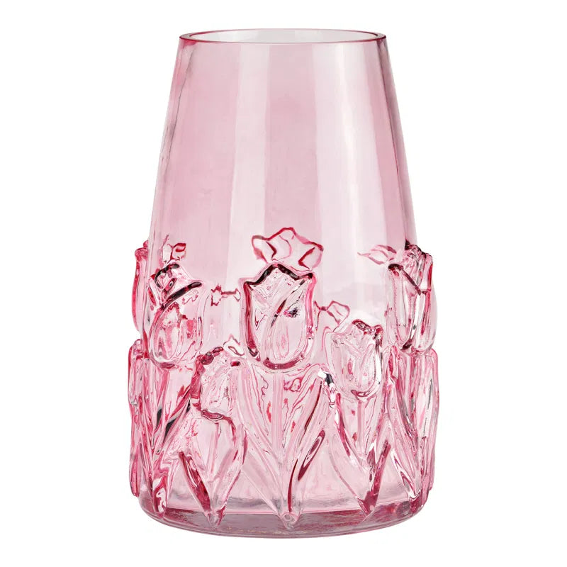 Pink glass vase with floral design on a white background