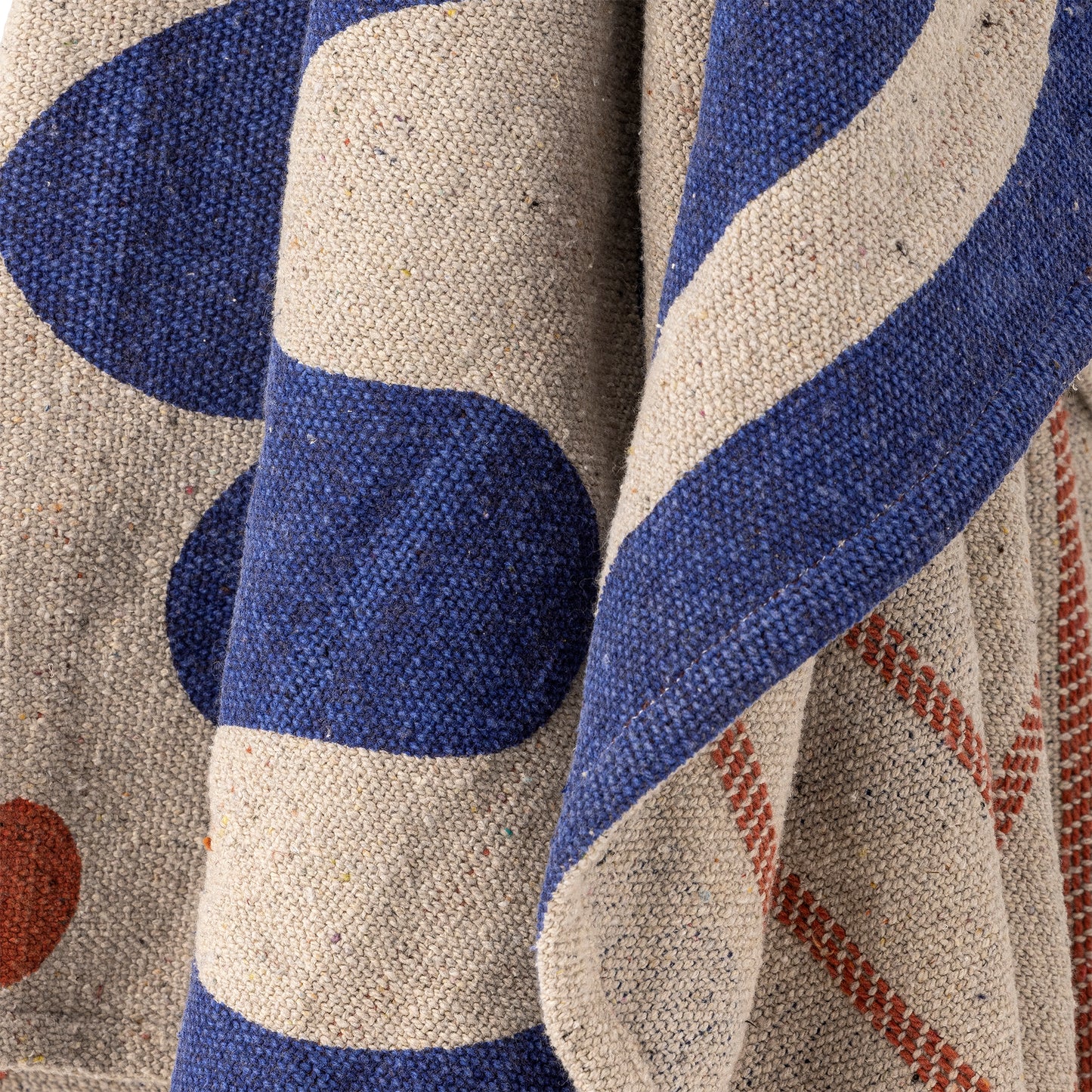 Close-up of a textured fabric with blue and beige patterns