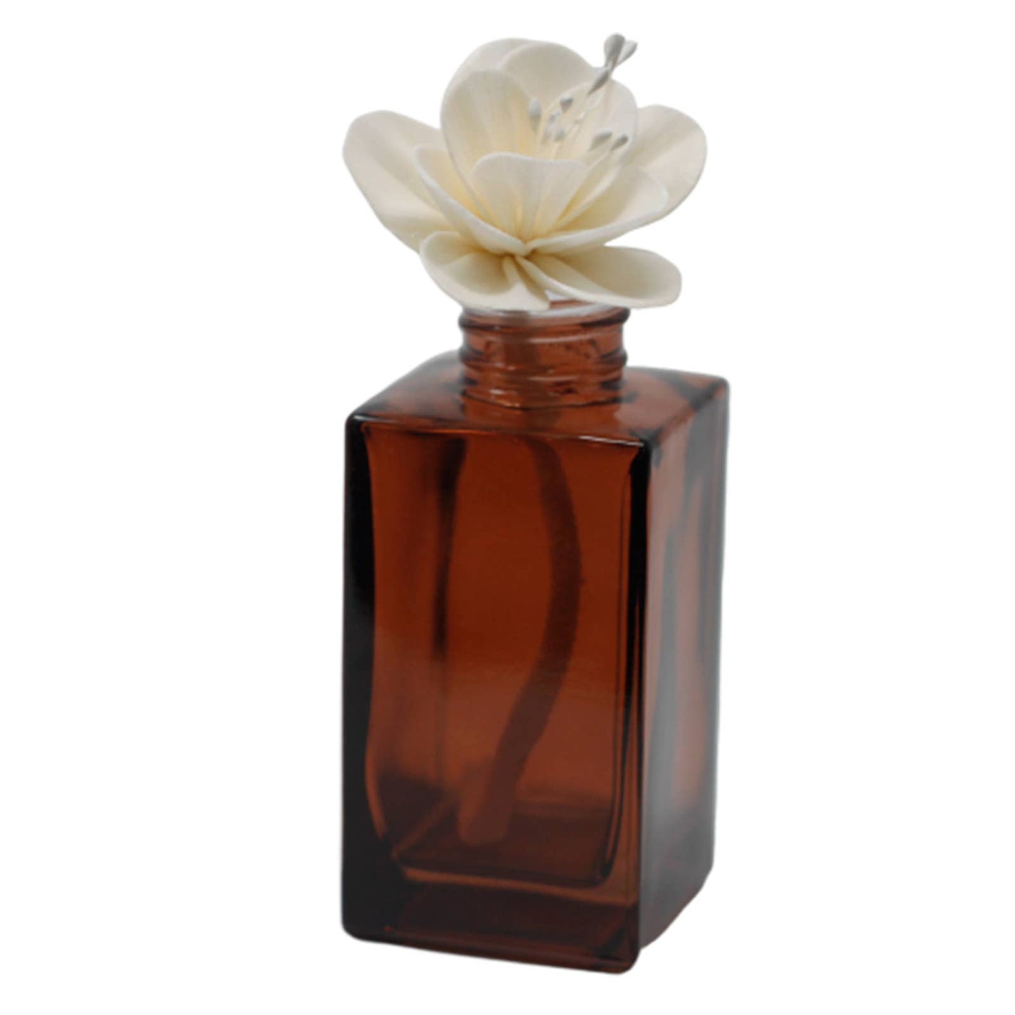 Brown perfume bottle with a white flower on a white background
