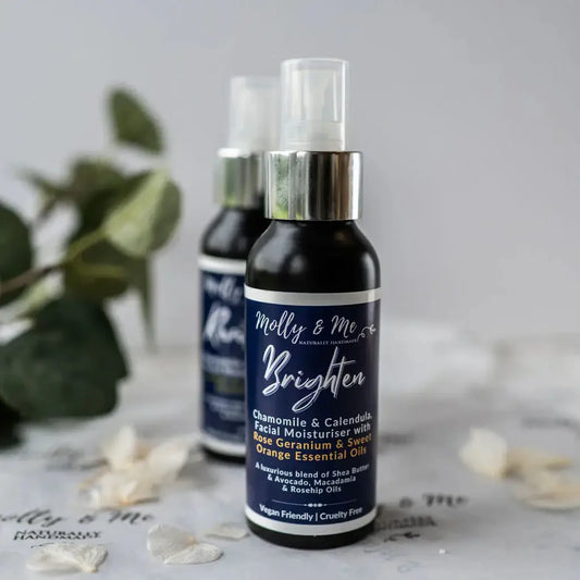 Two bottles of 'Molly & Me' facial moisturizer on a light surface with greenery in the background.