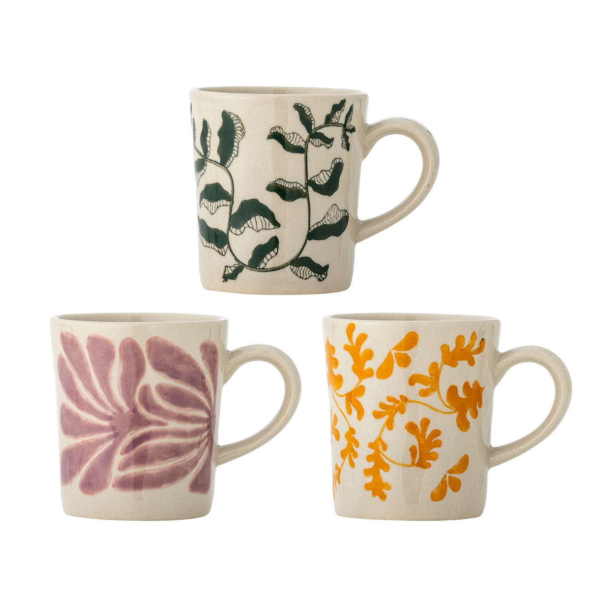 Three ceramic mugs with floral patterns on a white background
