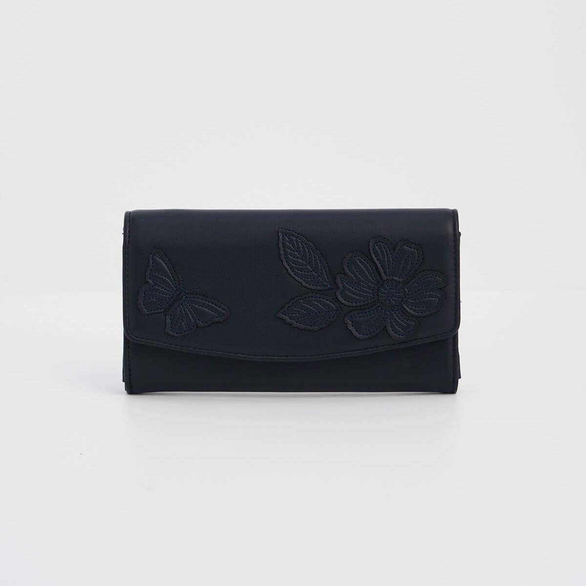 A dark navy blue leather clutch wallet featuring embossed floral and butterfly designs on the front flap, set against a plain light gray background.