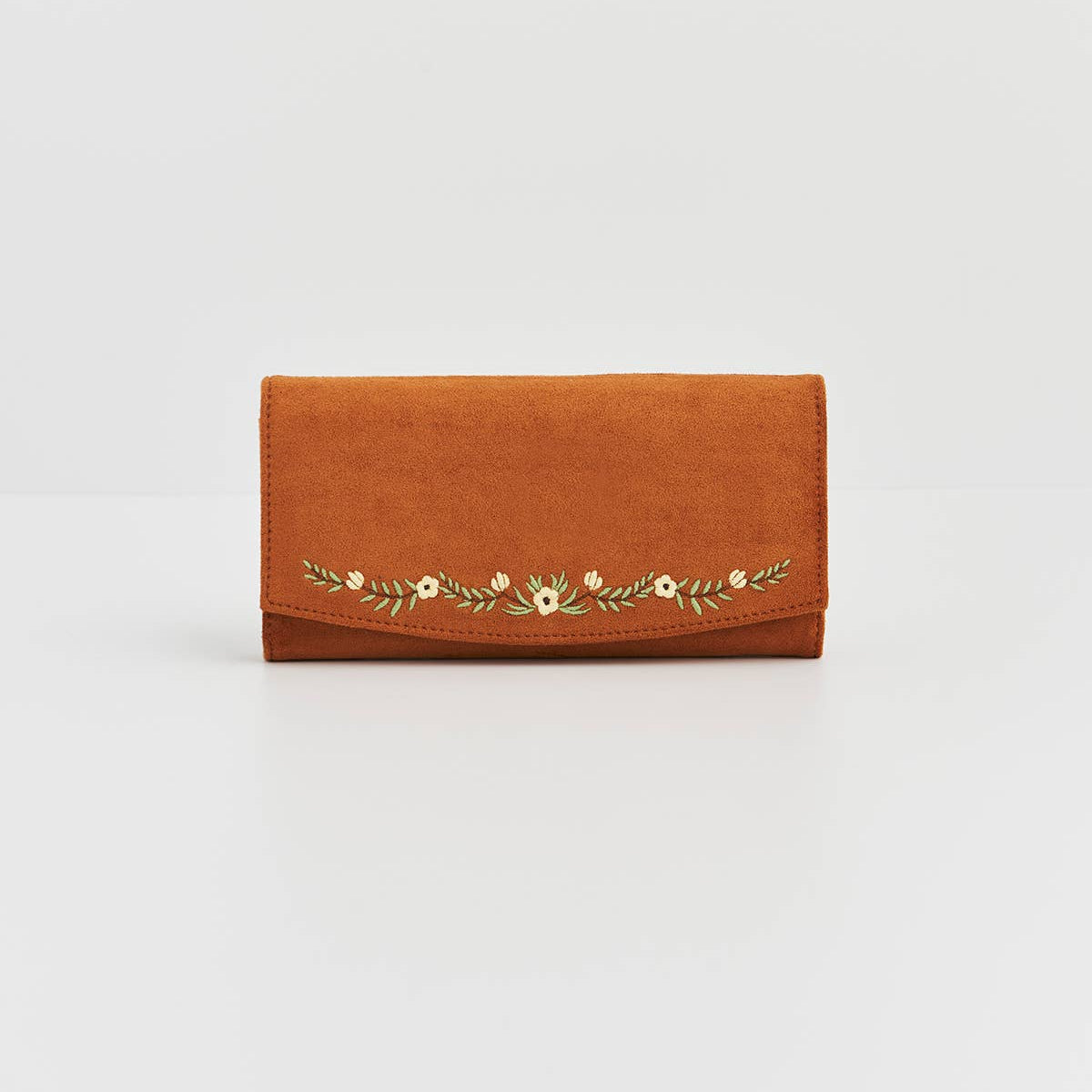 Brown wallet with floral embroidery on a light gray background