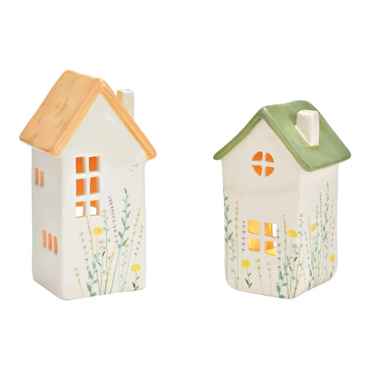 Two small house-shaped lanterns with colorful roofs on a white background
