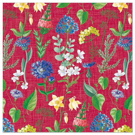 A close-up of a woven look print napkin  featuring a repeating floral pattern on a bright pink-red background, with green leaves, blue and white flowers, yellow blossoms, and small pink flowers.