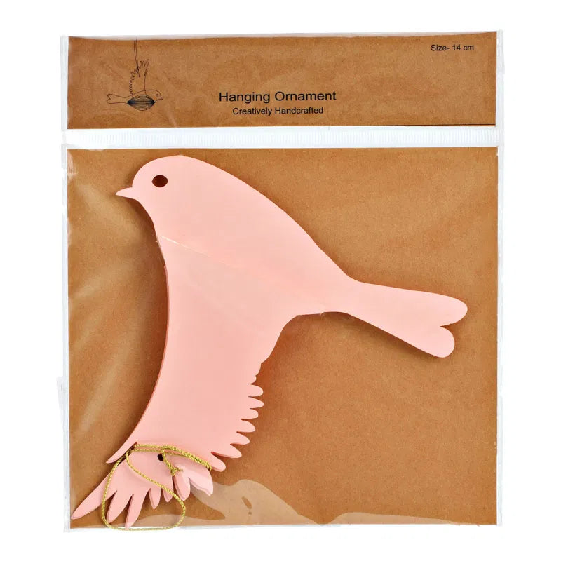 Pink dove-shaped hanging ornament in clear packaging on a brown background