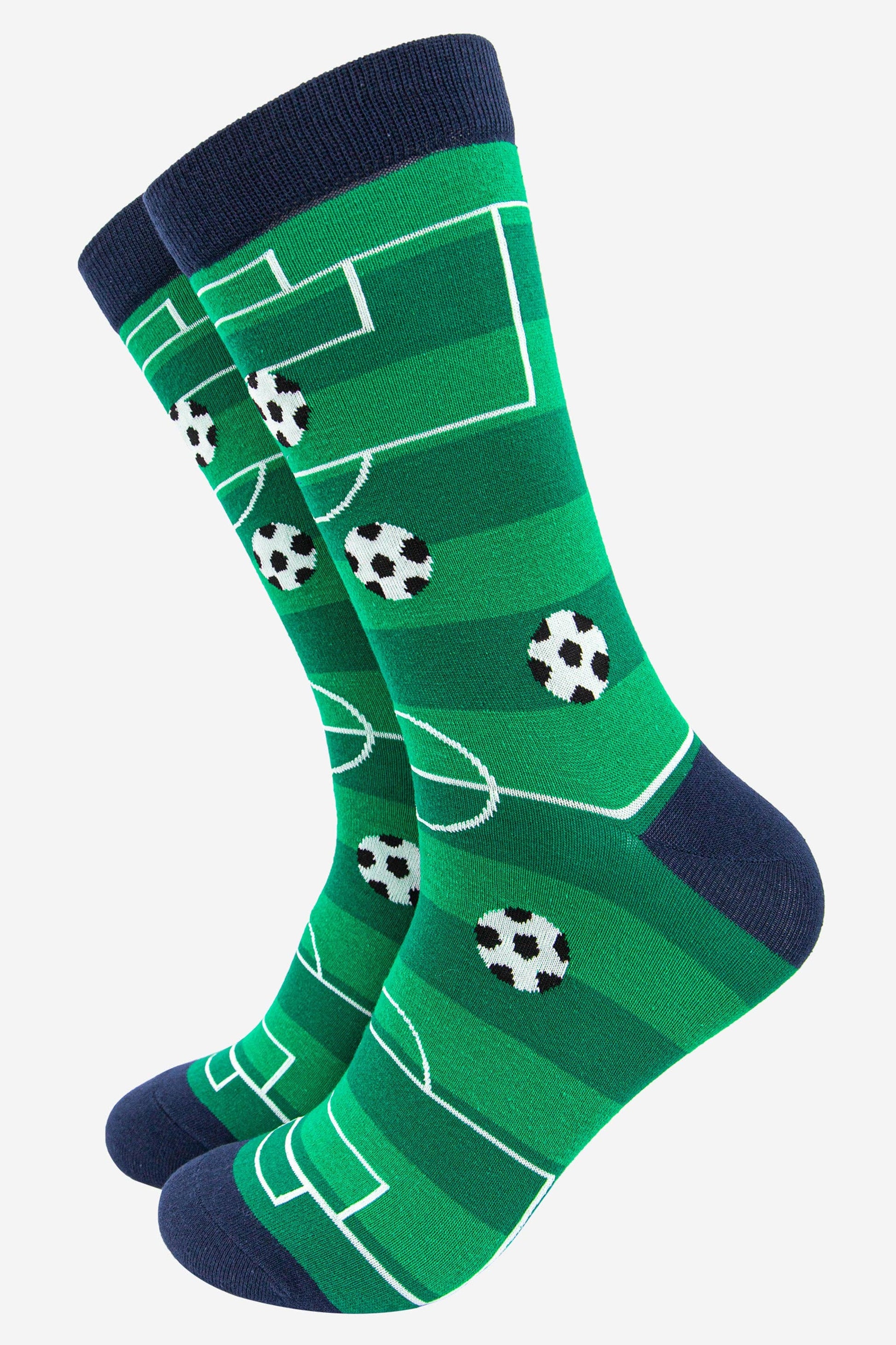 Green socks with soccer field and ball pattern on a white background