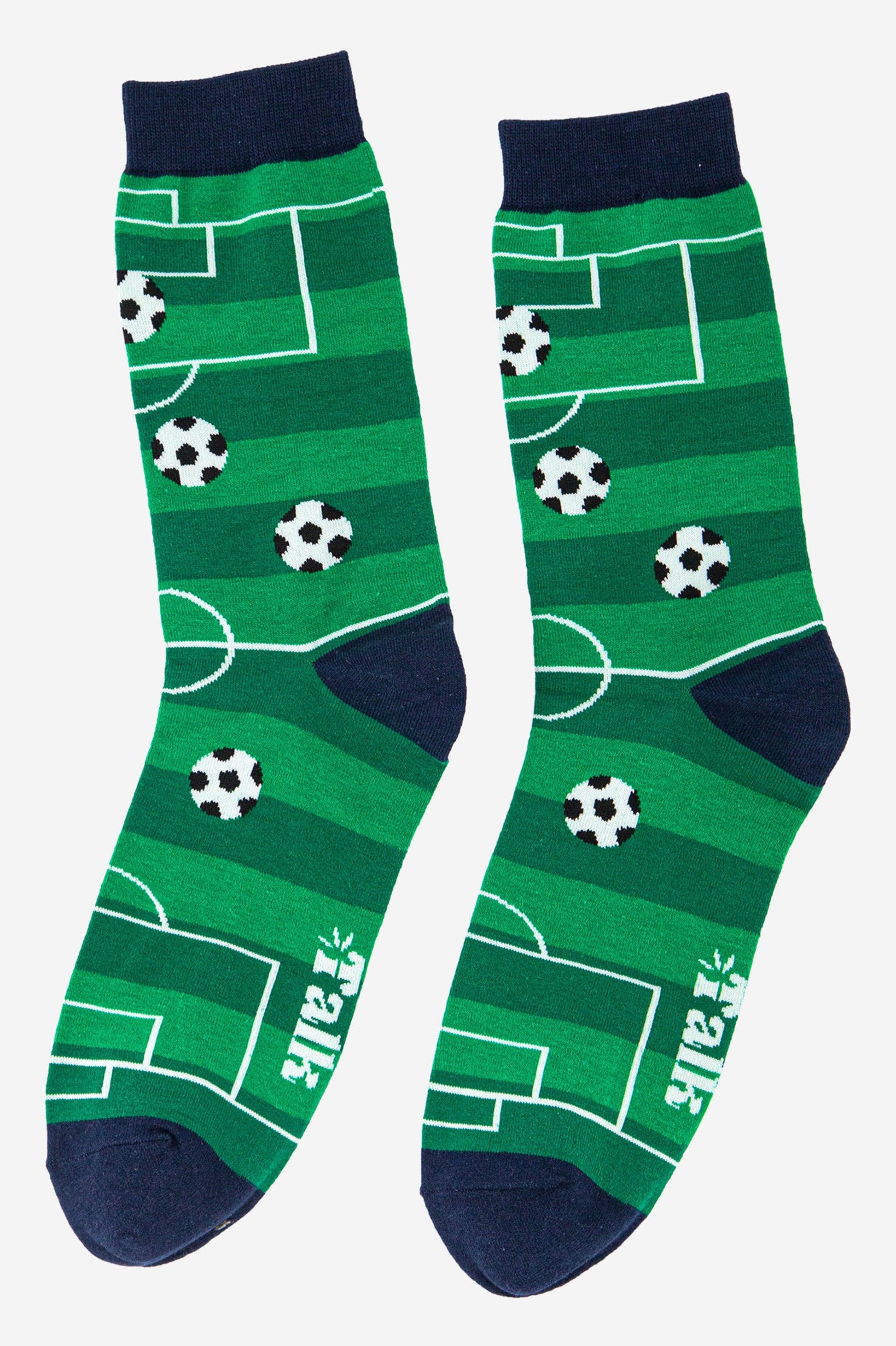 Green socks with soccer field pattern and black accents on a white background
