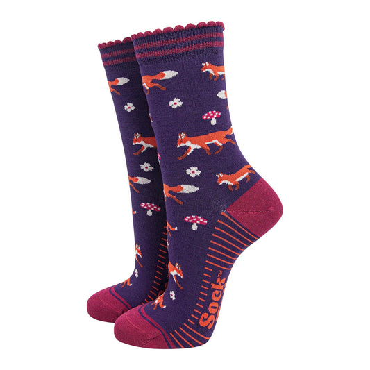 Pair of socks with fox and mushroom pattern on a white background