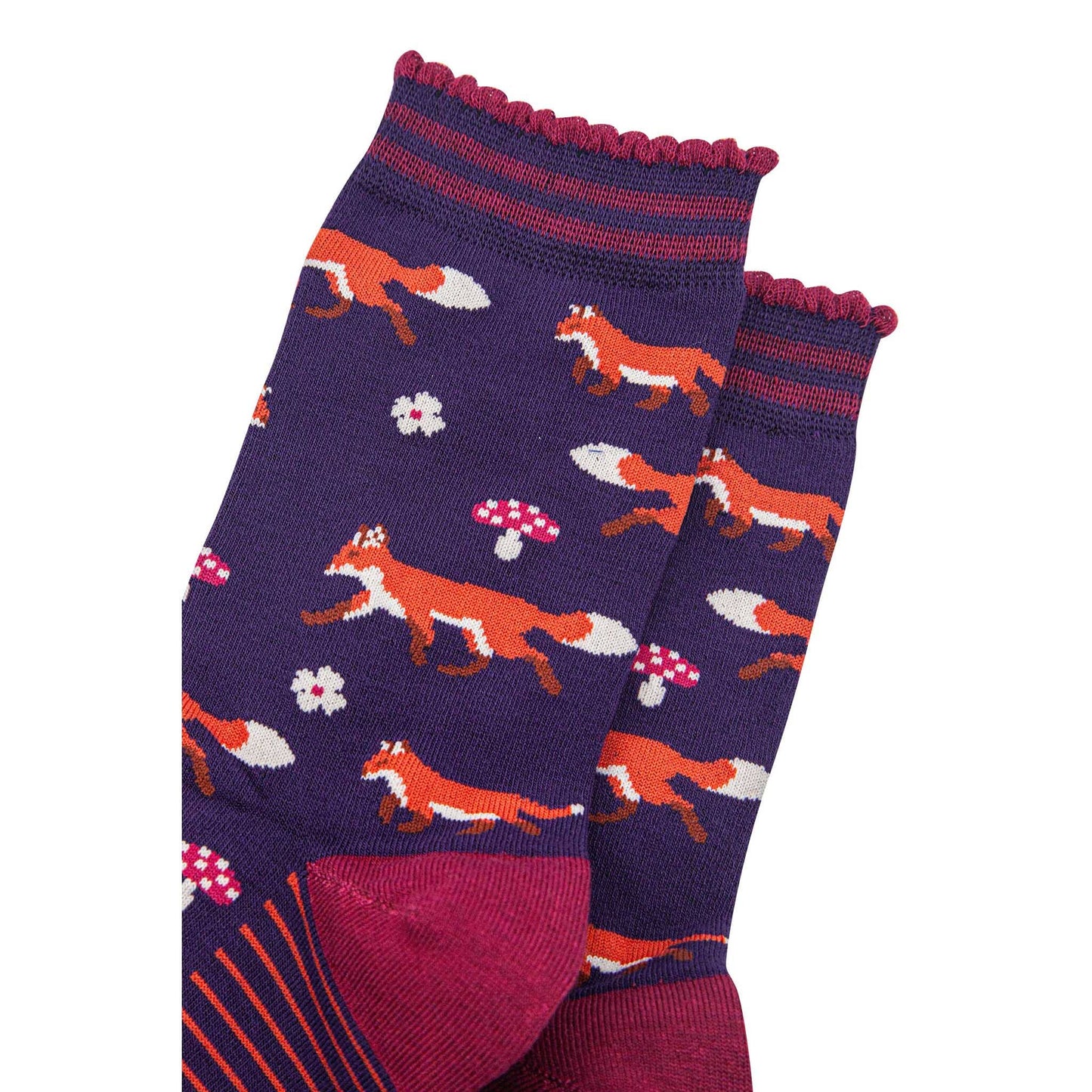Purple socks with fox and mushroom pattern on a white background