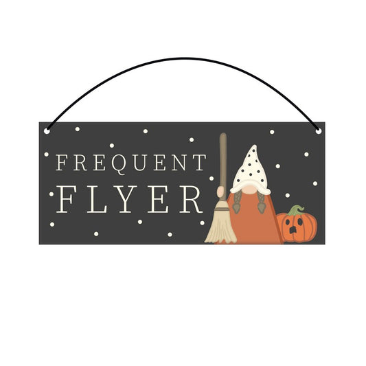 Frequent Flyer Halloween Sign with gonk holding broomstick beside a pumpkin
