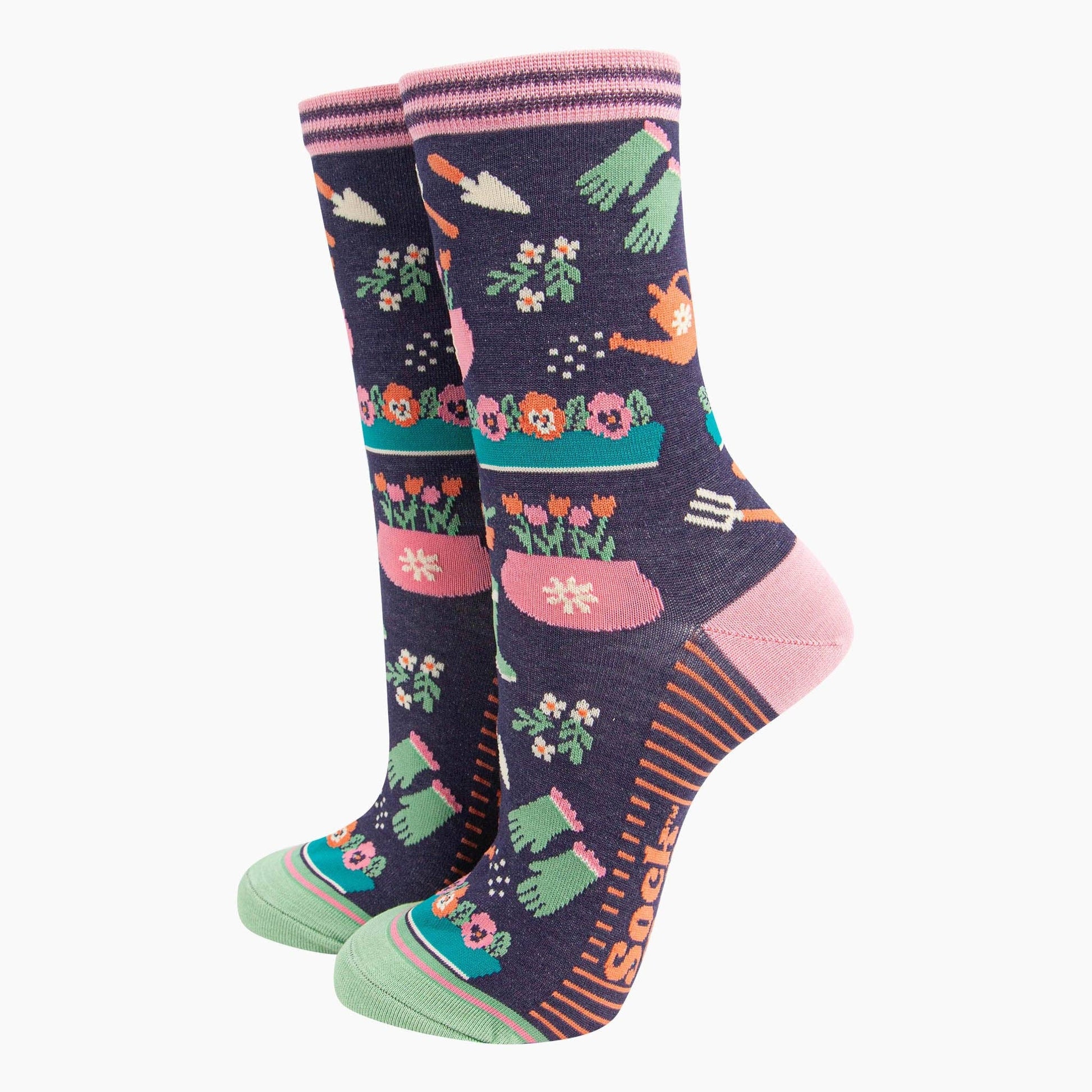Pair of socks with gardening-themed design on a white background