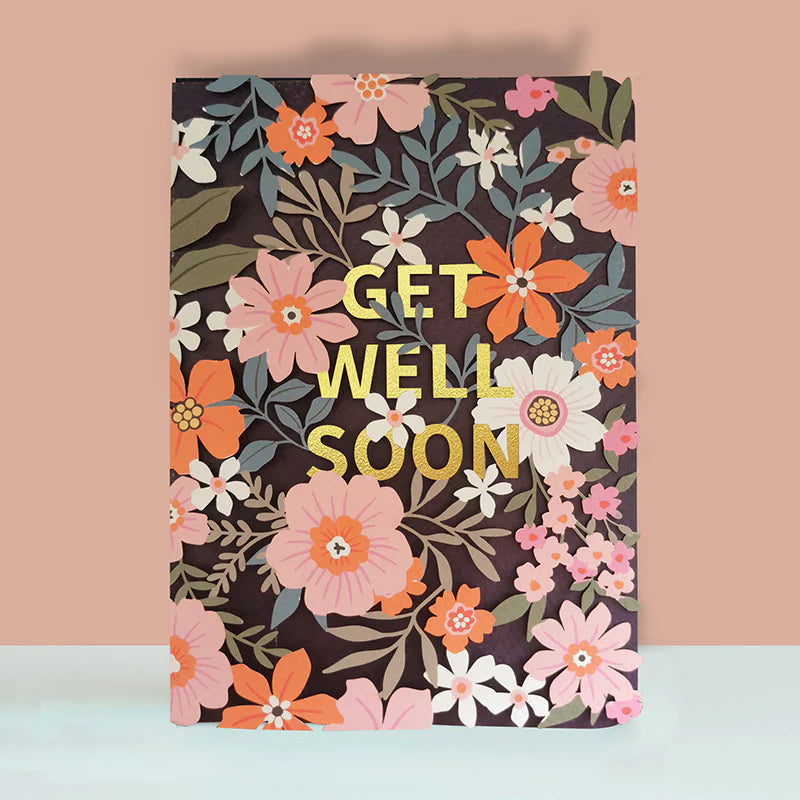 Floral notebook with 'Get Well Soon' text on a pink and blue gradient background