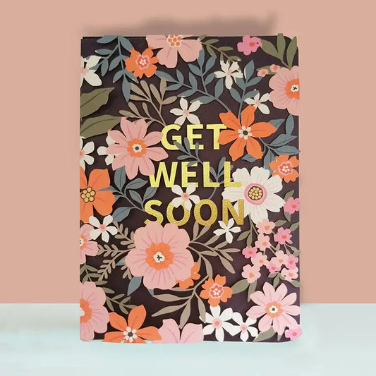 Floral notebook with 'Get Well Soon' text on a pink and blue gradient background
