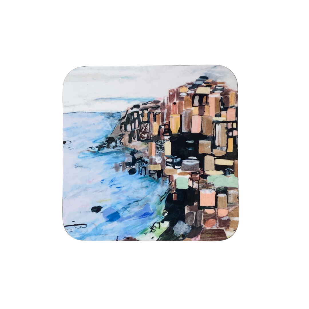 Square coaster with a colorful mosaic design of the Giants Causeway and water on a white background