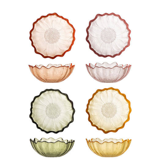 Set of four glass bowls in various colors on a white background
