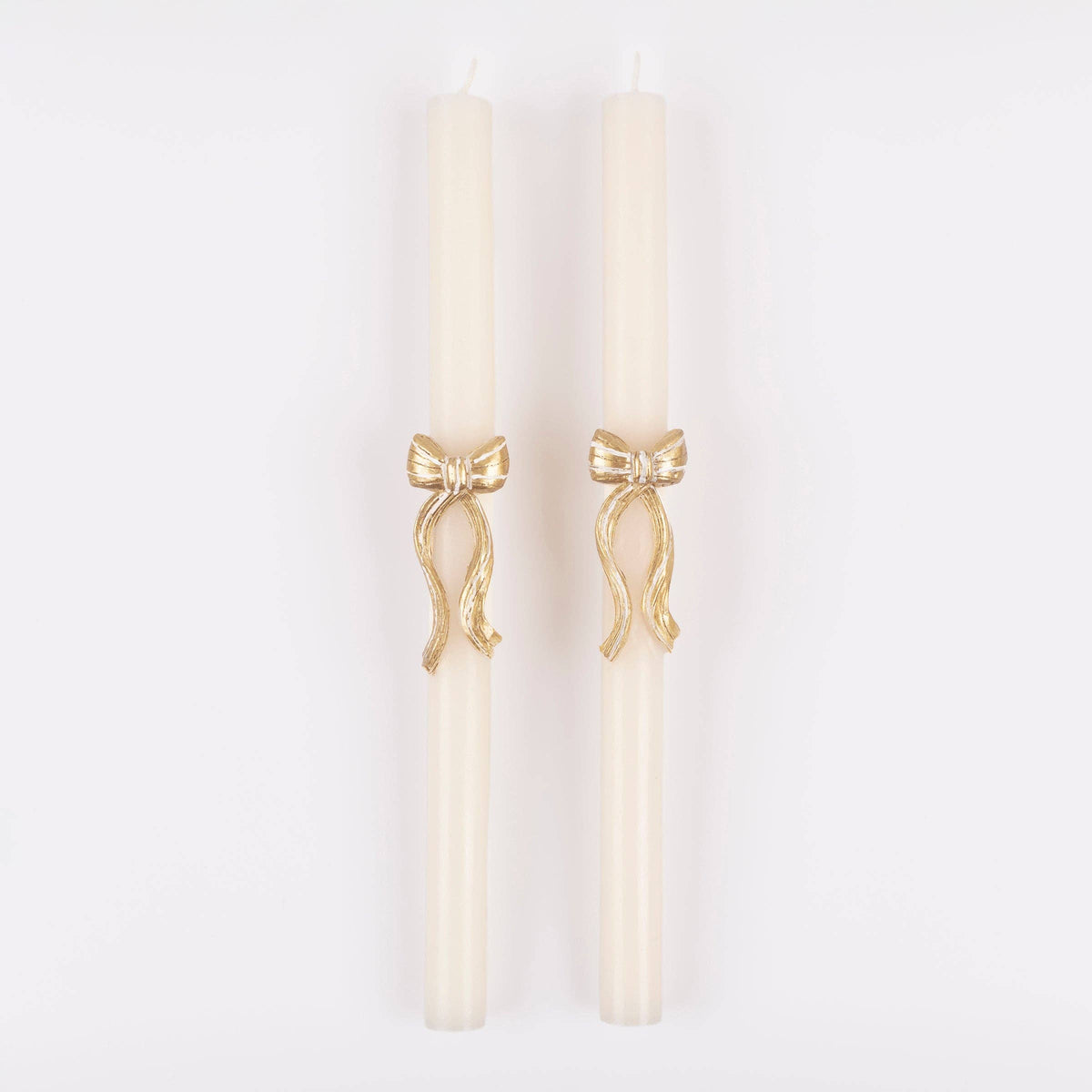 Two taper candles with gold bow detail