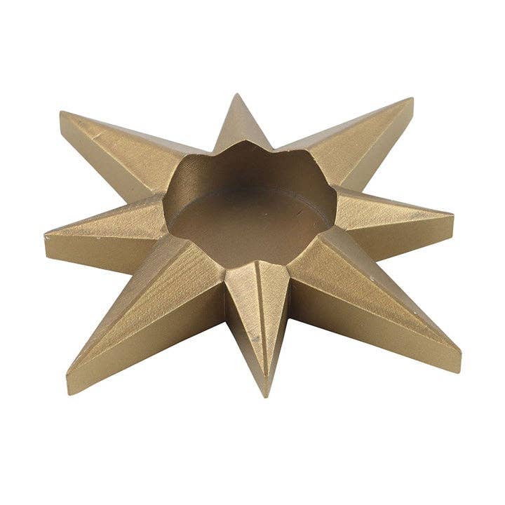 Gold star-shaped decorative tealight holder on a white background