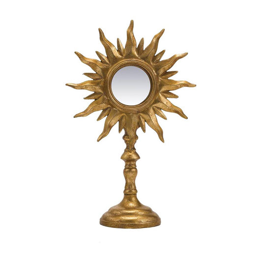Decorative gold sun-shaped mirror on a white background