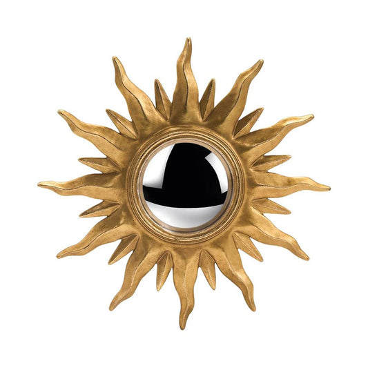 Decorative sun-shaped mirror with gold rays on a white background