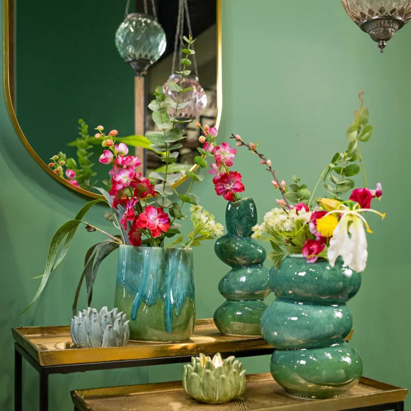 Green Vase on a sideboard