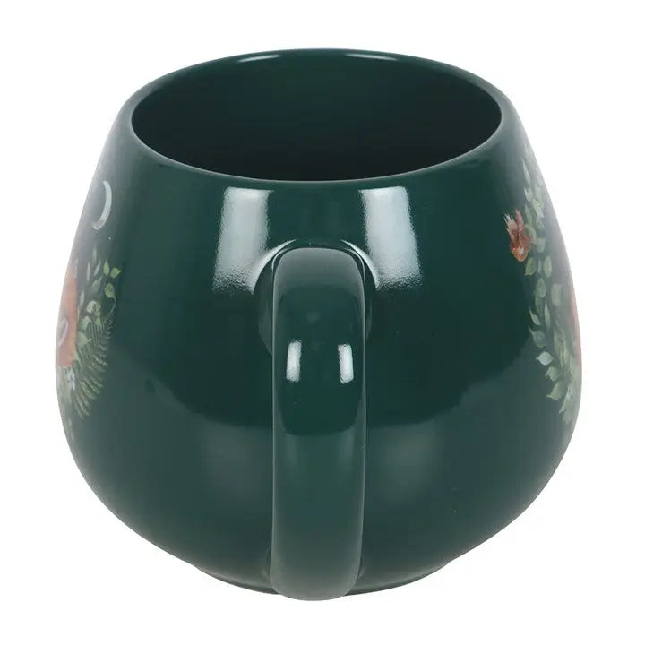 Green mug with decorative patterns on a white background