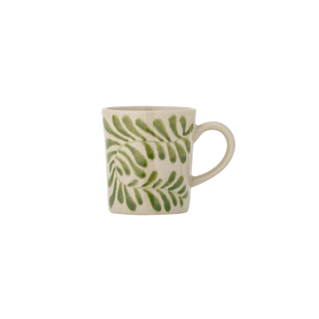 A small ceramic mug with a green leaf pattern on a cream-colored glaze, featuring a C-shaped handle, set against a plain white background.