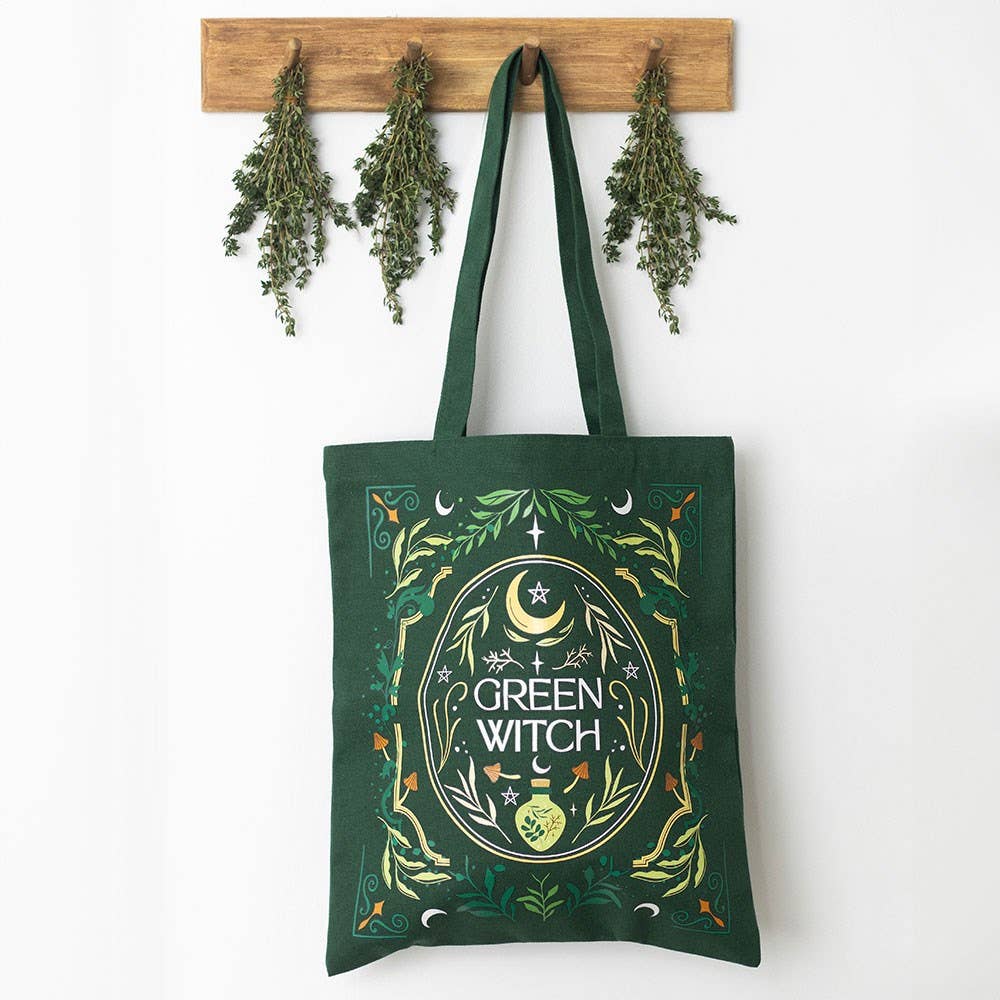 Green Witch Tote Bag hanging on a wall