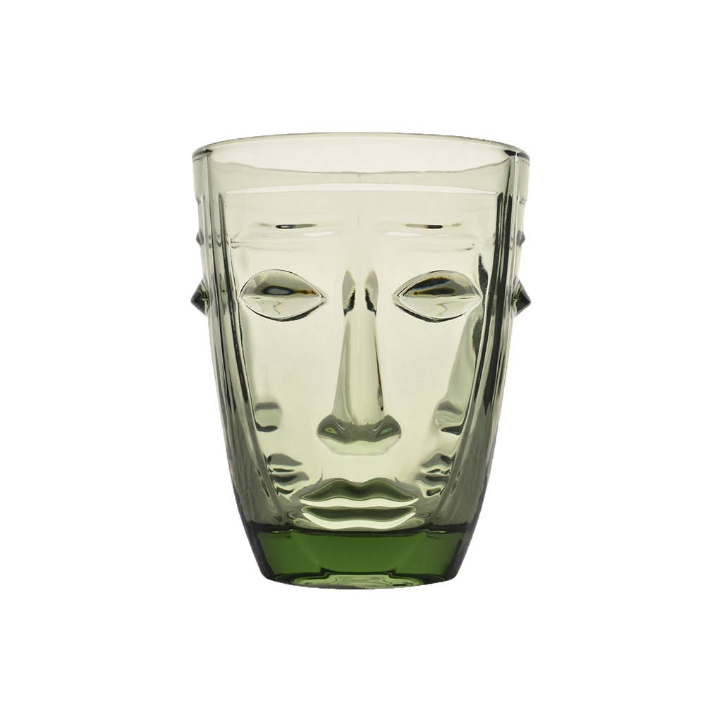 Clear drinking glass with face design on a white background