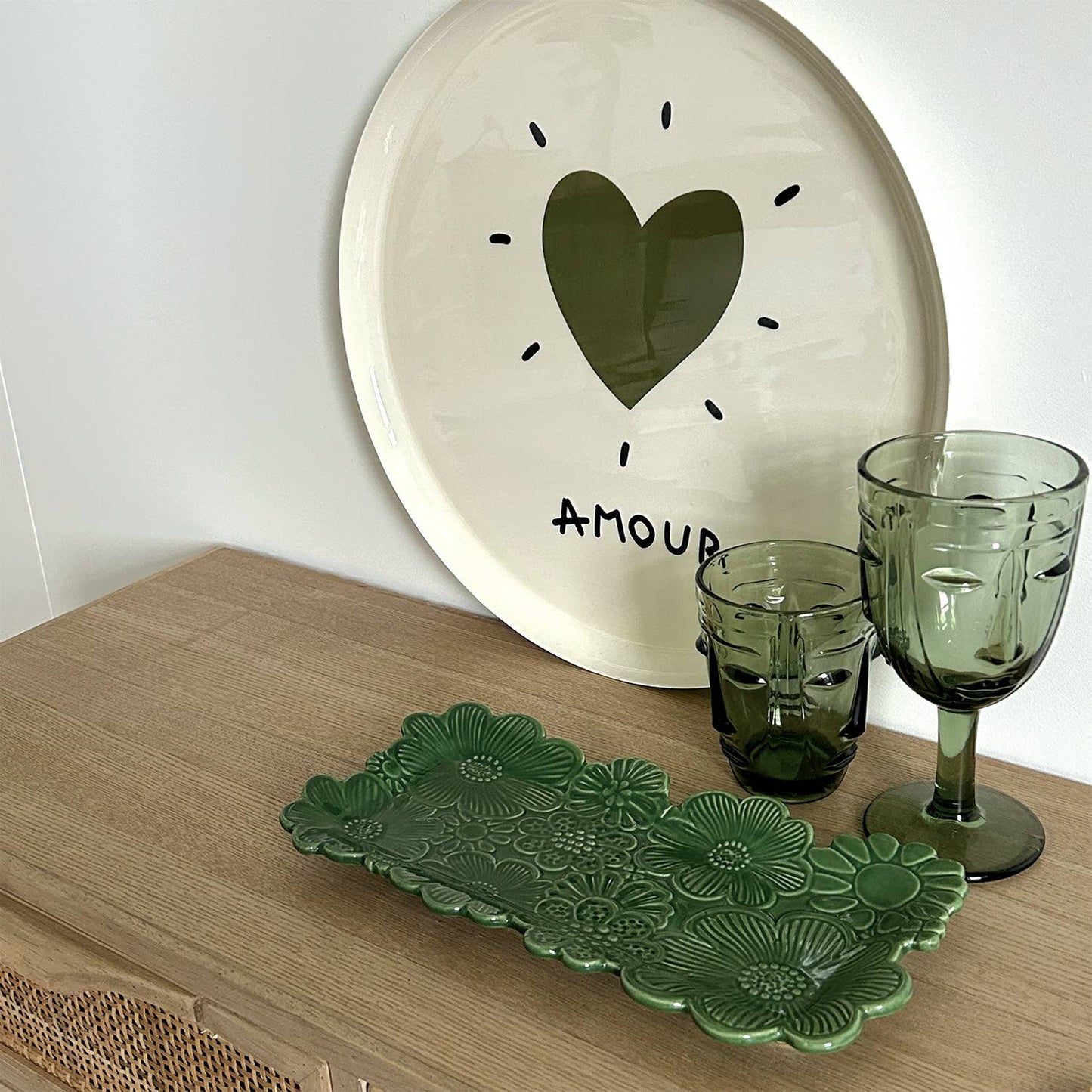 Selection of drinking glassed with face design on a sideboard