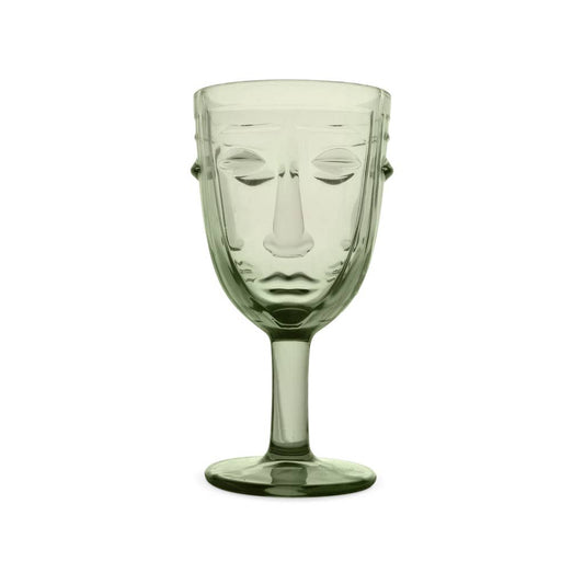 Clear glass goblet with face design on a white background