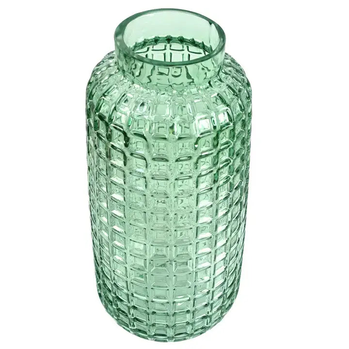 A green glass vase with a cube embossed pattern, tall and slender in shape, displayed from overhead against a white background.