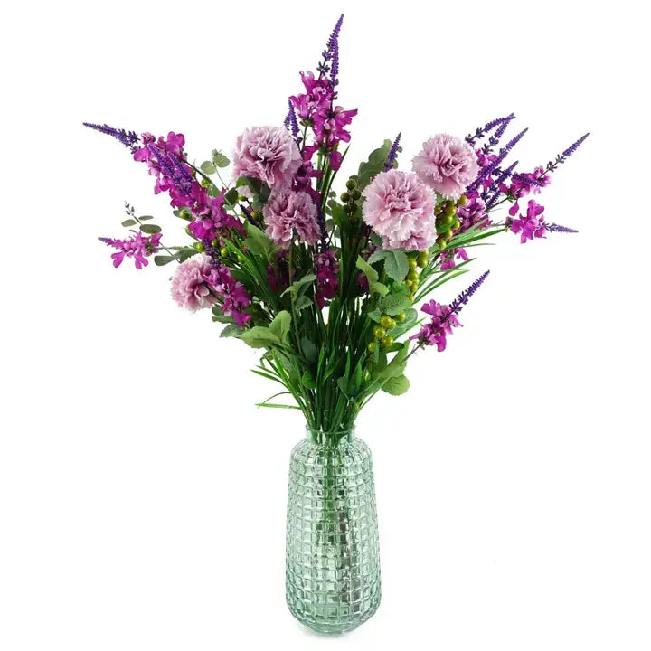 A green glass vase with a cube embossed pattern, tall and slender in shape, displayed filled with purple flowers against a white background.