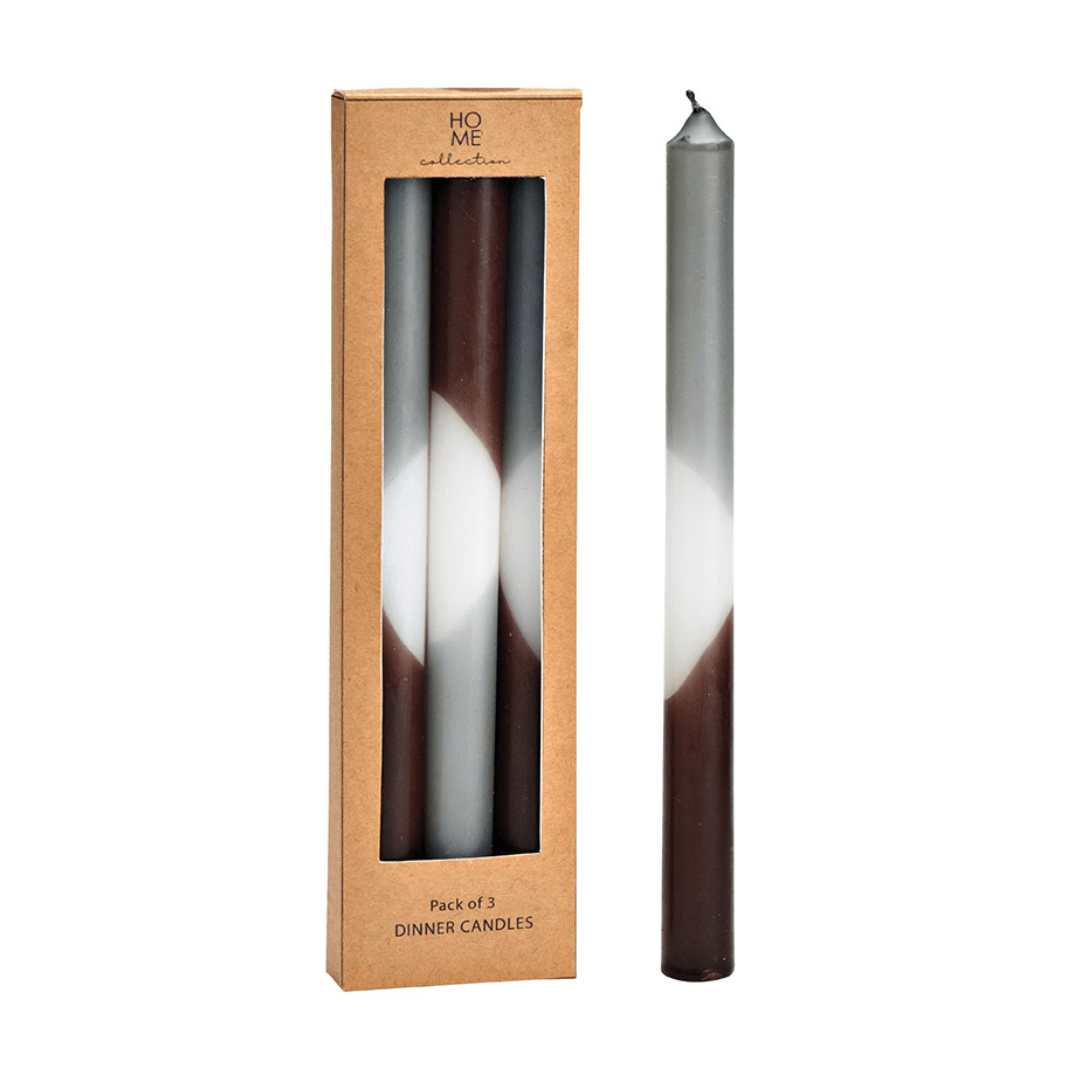 Tall taper candle with gradient design in a cardboard packaging labeled 'Home Collection'.