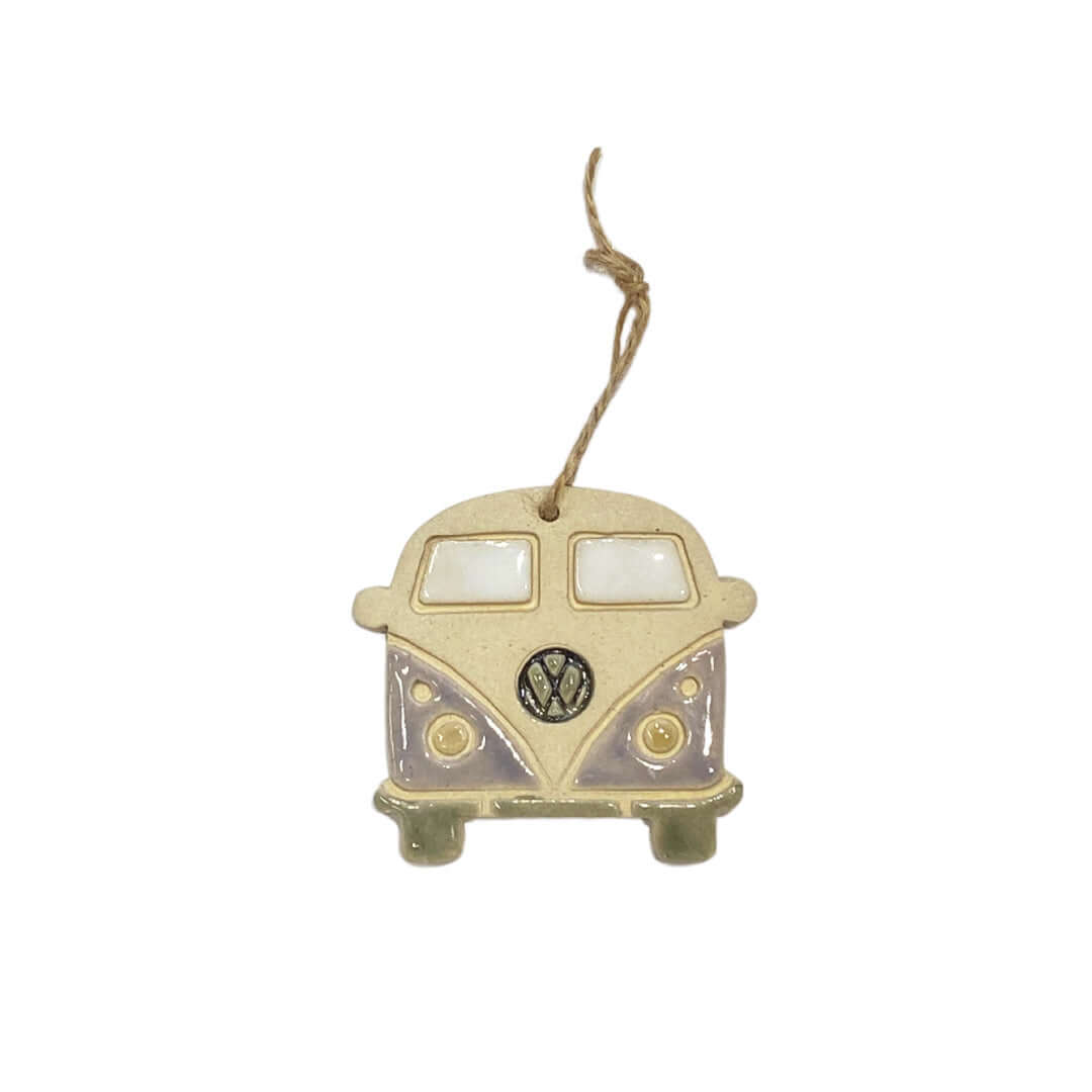 A ceramic decoration in the shape of a retro VW camper van, hanging from a string.