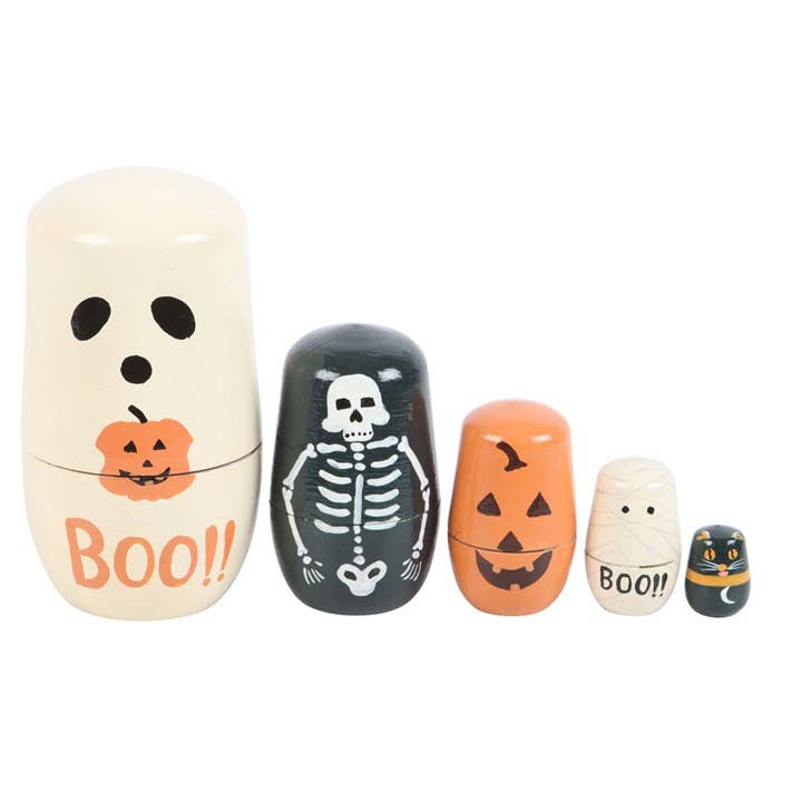 Set of Halloween-themed nesting dolls with ghost, skeleton, and pumpkin designs on a white background.