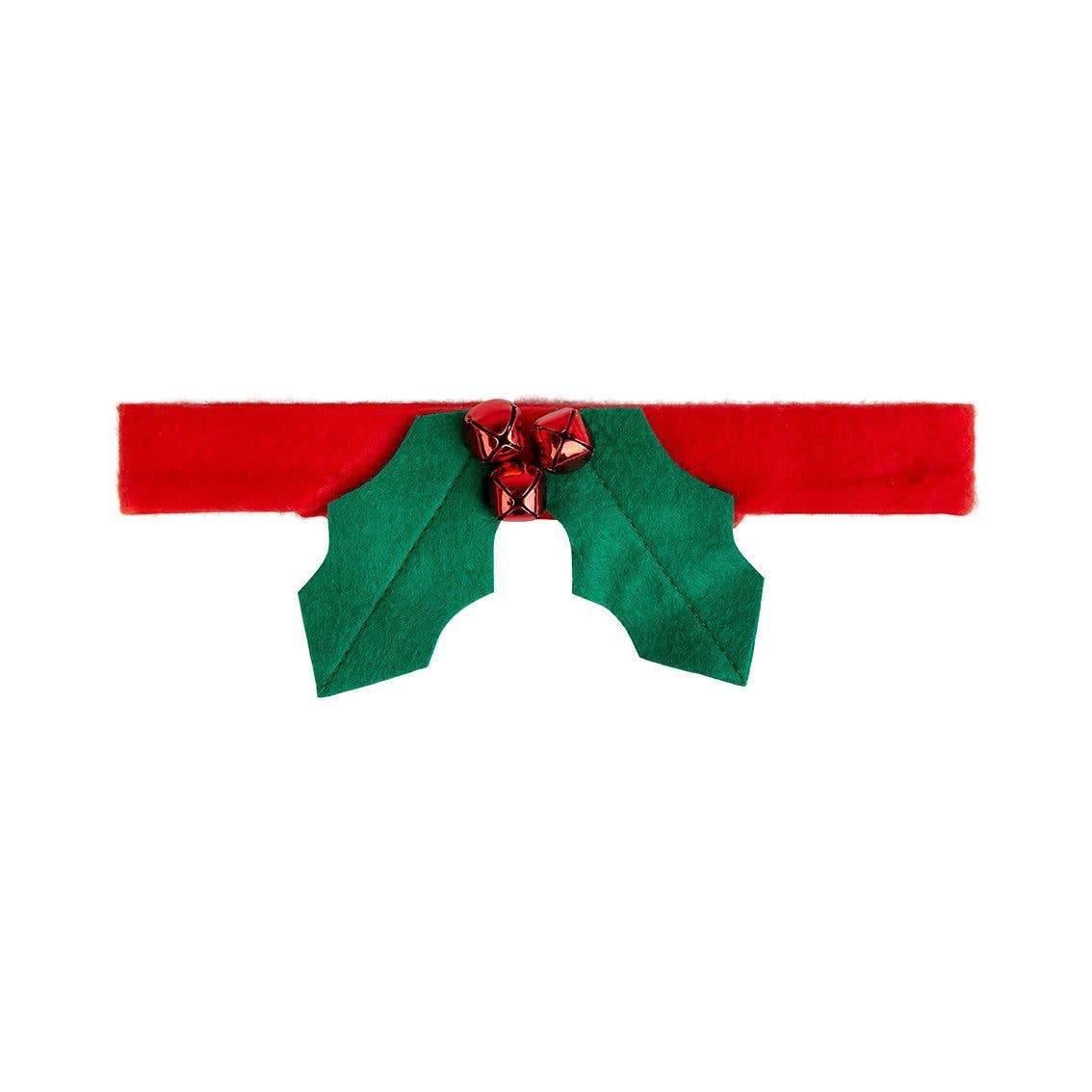 Red headband with green holly leaves and red bells on a white background