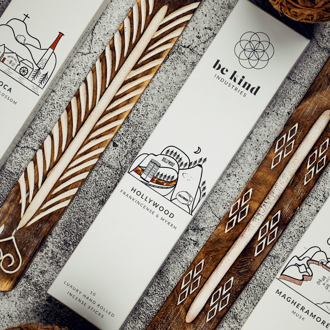 Wooden incense sticks with branded packaging on a textured surface